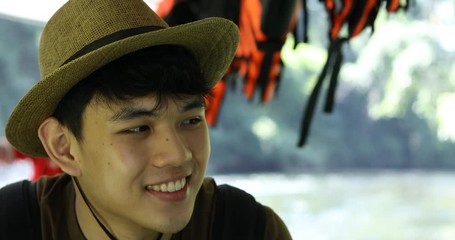 Male tourists sitting on a scenic boat, men wearing hats to travel, travel nature