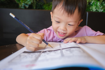Cute Asian 3 - 4 years old toddler boy child writing / drawing with pencil, Student doing homework, Little kid prepare for kindergarten test, Creative play for toddler, improve focus in child concept