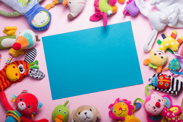 Colorful kids toys frame on wooden background. Top view. Flat lay. Copy space for text.