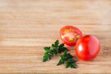 Tomato and half a tomato with a sprig of parsley