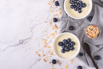 Yogurt with fresh blueberries on wooden background. Health concept.