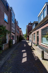 Fototapeta na wymiar Lange Wijngaardstraat, a small and quiet street in the historical center of Haarlem
