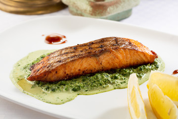 Grilled red fish and spinach sauce, food close-up