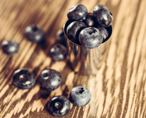 Delicious fruit berries in a small metal bowl, blue berry and red currant.