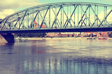 Fototapeta premium Metal bridge in Torun, Poland. Vistula river. Filtered vintage color style.