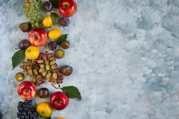 Assortment healthy organic fruits apple grapes fig plums tangerines