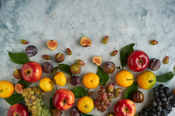 Assortment healthy organic fruits apple grapes fig plums tangerines