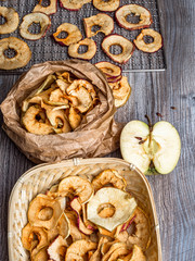 Tasty apple chips on wooden table, healthy vegan vegetarian fruit snack or ingredient for cooking