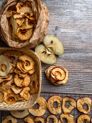 Tasty apple chips on wooden table, healthy vegan vegetarian fruit snack or ingredient for cooking