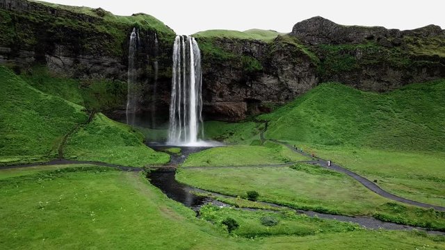 4K Aerial Drone footage from the sky of Iceland waterfall valley in the southern region. Beautiful green Icelandic landscape