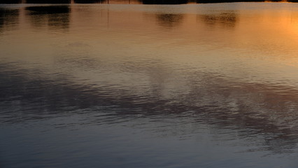  Sunset on the river. Dusk. Reflection in water. Water surface