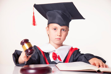 Portrait of serious child girl judge (lawyer) makes a decision. Humorous photo.
