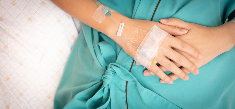Female patient's hand lay on the stomach due to having a stomach ache From diarrhea.
