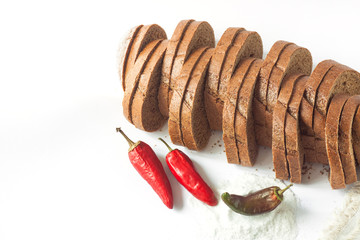 Rye bread with red chili peppers and salt on a white background isolated.