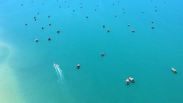 Aerial View Of Stunning Beautiful Turquoise Sea landscape With Boats Moored And Speedboat Moving Near Pesalai Beach, Sri Lanka