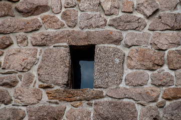 small window in stone wall .Lozere , France 