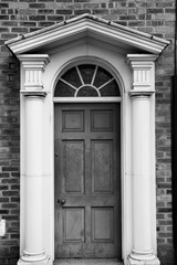 Georgian door in the UK. Black and white vintage style.