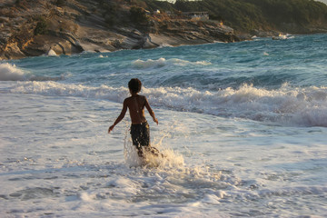 African american boy frolic and swimming in the sea