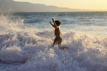 African american boy frolic and swimming in the sea