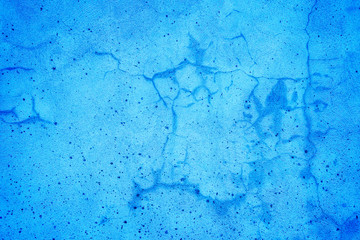Blue painted old cracked wall texture background.