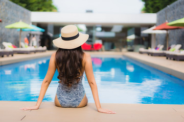 Beautiful portrait asian woman relax happy smile around outdoor swimming pool