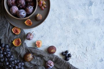 healthy fruits in assortment in plates grapes fig plums