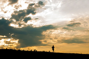 Naklejka na ściany i meble Silhouette women's runners run on hillside at sunset. jogging workout wellness concept.