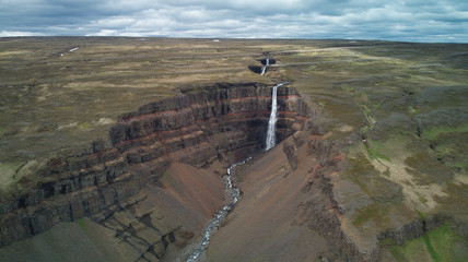 Aerial photography of several waterfalls in Iceland where the different tectonic layers are seen.