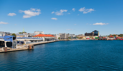 Fototapeta premium Beautiful seascape norwegian coastline, coast of Kristiansand with buildings, Scandinavia, Norway. July 2019