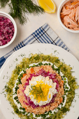 Traditional Russian Mimosa salad with salmon cheese and potatoes. Top view