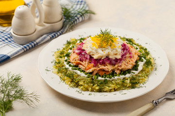 Traditional Russian Mimosa salad with salmon cheese and potatoes. Front view
