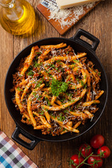 Maccheroni al ferretto with beef in ragu bolognese. Top view.