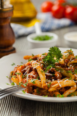 Maccheroni al ferretto with beef in ragu bolognese. Front view.