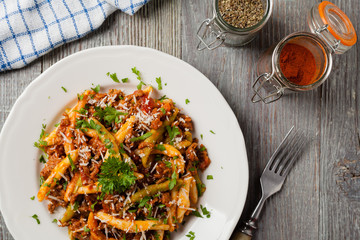 Maccheroni al ferretto with beef in ragu bolognese. Top view.