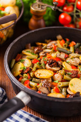 Fried pan vegetables, with mushrooms and dried tomatoes. Seasoned with a mix of herbs.