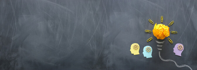 Education concept image. Creative idea and innovation. Crumpled paper as light bulb metaphor over blackboard