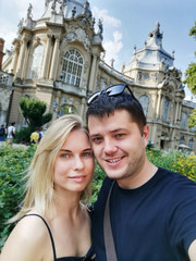 Image of young couple in love on walk in city against backdrop of attractions