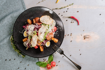 Dish with shrimp meat, vegetables and croutons on the wooden background