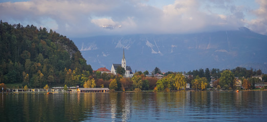 Fototapeta na wymiar Travailing around Lake Bled In Slovenia an amazing lake full of impressive nature , crystal blue water with a beautiful island in the middle surrounded by those beautiful mountains and trees. 