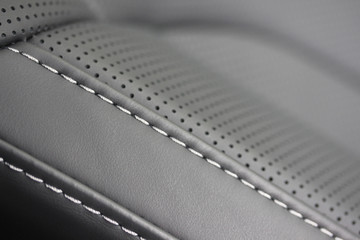 Vehicle leather seat with white stitching and perforation