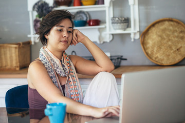 woman using laptop computer at her home