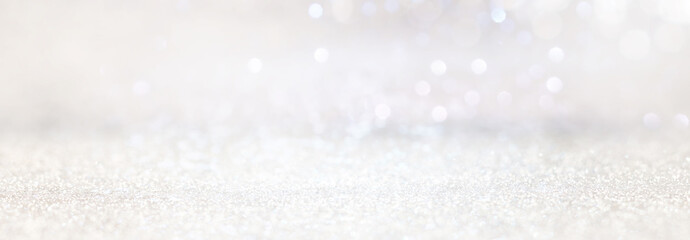 abstract backgrounf of glitter vintage lights . silver and white. de-focused. banner