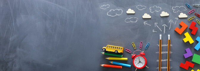 Education concept of Ladder made from pencils next to clouds over blackboard