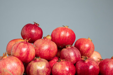 Pomegranates on the grey isolated background
