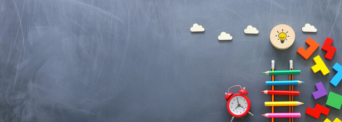 Education concept of Ladder made from pencils next to clouds over blackboard