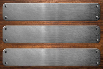 Metal signboard on wooden background