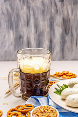 Oktoberfest set. Dark beer, weisswurst, pretzels, mustard, spikelets of grain, hop