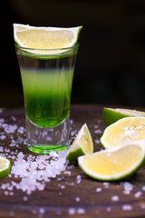 Alcohol cocktail with tequila and slice of lime
