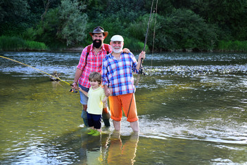 Senior man fishing with son and grandson. I love fishing. Happy people family have fishing and fun together. Old and young.