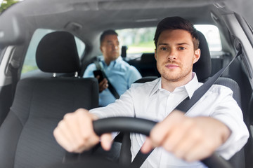 transport, vehicle and people concept - male driver driving car with passenger